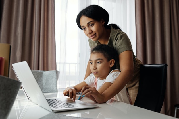 A person and a child looking at a computer

Description automatically generated with medium confidence