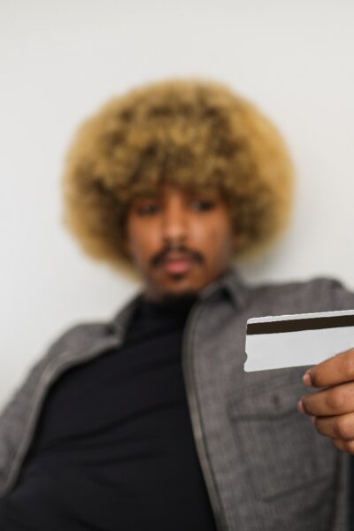 A person holding a credit card Description automatically generated